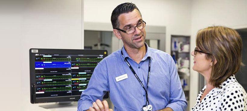 Nurse unit managers discussing patient notes