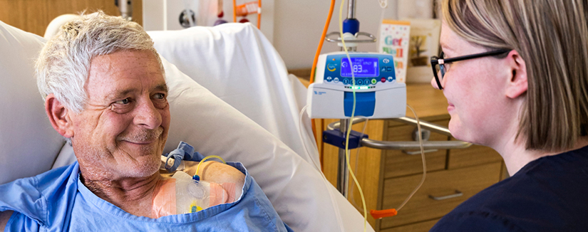 old man smiling at a nurse