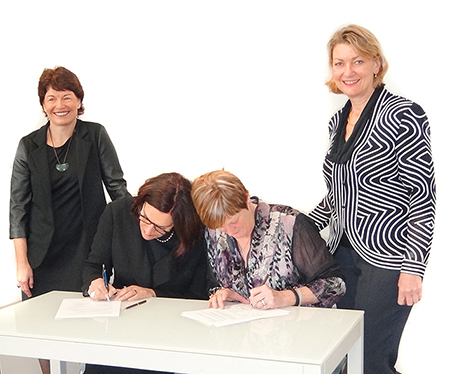 Photo of the signing of a memorandum; Dr Deborah Rowe, Carolyn Reed, Alyson Smith and Anne Copeland