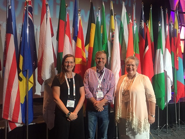 Members of the NMBA and the AHPRA midwifery policy team stand in front of national flags at ICM Congress 2017