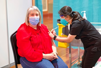 Amanda Singleton, Chair of the Victorian Board of the NMBA, receives a COVID-19 vaccination