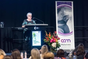 Woman standing behind a lectern
