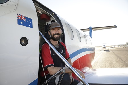 Man sitting in airplane doorway