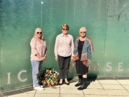 Three women with a wreath