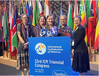 Five women standing behind a podium